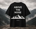Black t-shirt with 'Above the Noise' and mountain design on a mountainous background